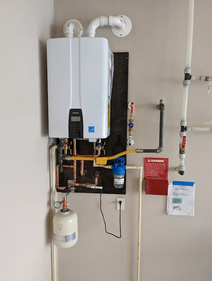 Professional plumber installing copper piping in a Millstadt home